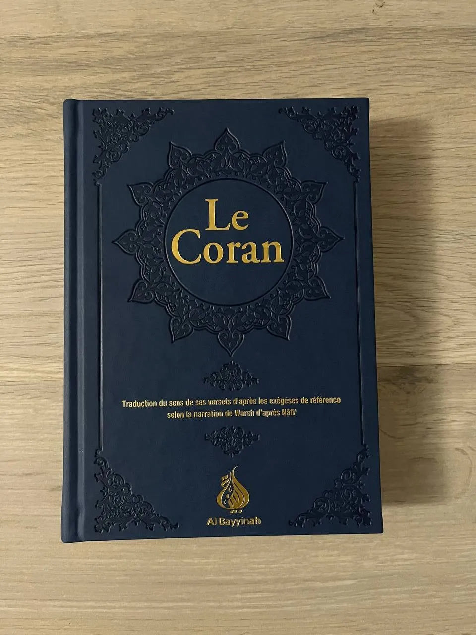 Coran en arabe et français par Rachid Maach, édition Al Bayyinah, couverture blanche avec titre en arabe et français.