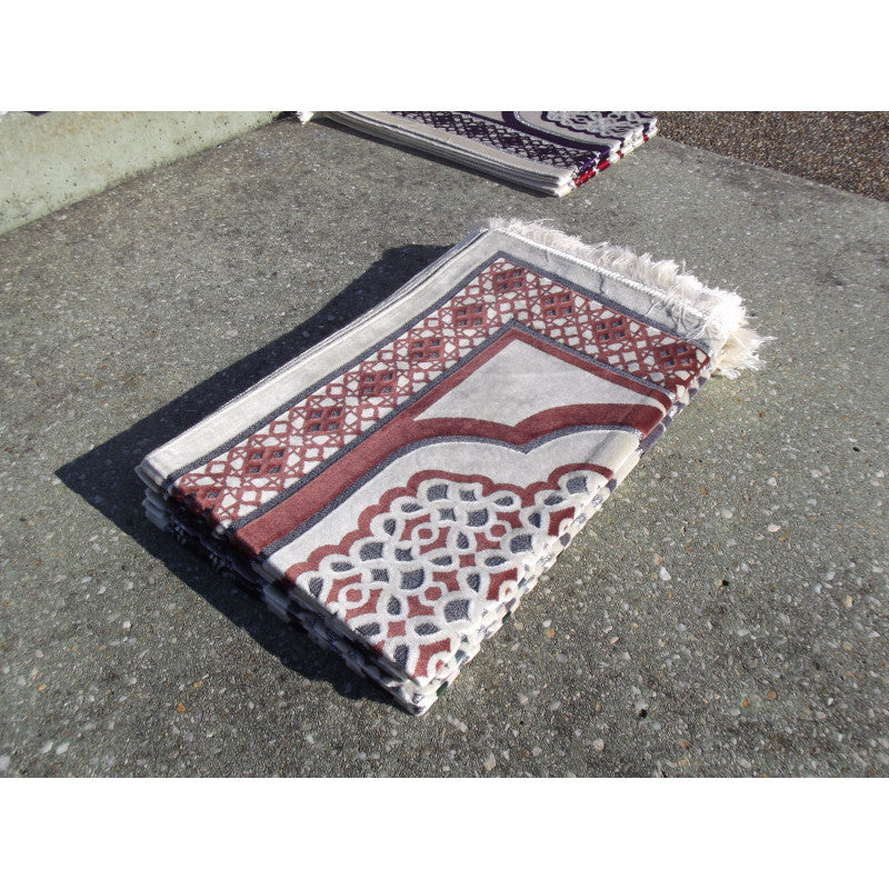 Tapis de prière Sana Edition avec contour géométrique en couleur terracotta sur fond blanc, motif élégant et moderne.
